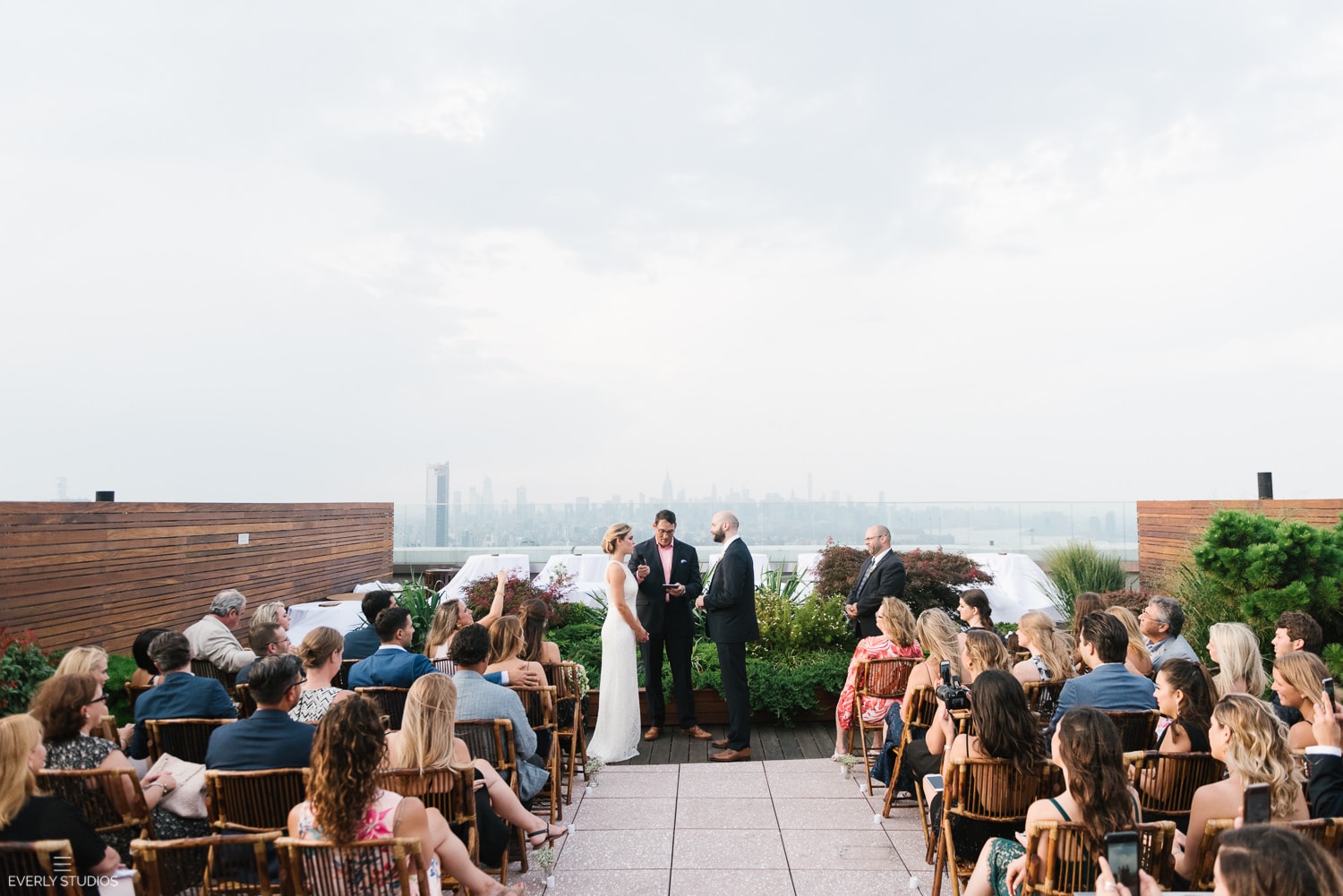 Rooftop wedding NYC in Brooklyn with views of Manhattan. Wedding photos by NYC wedding photographer Everly Studios, www.everlystudios.com